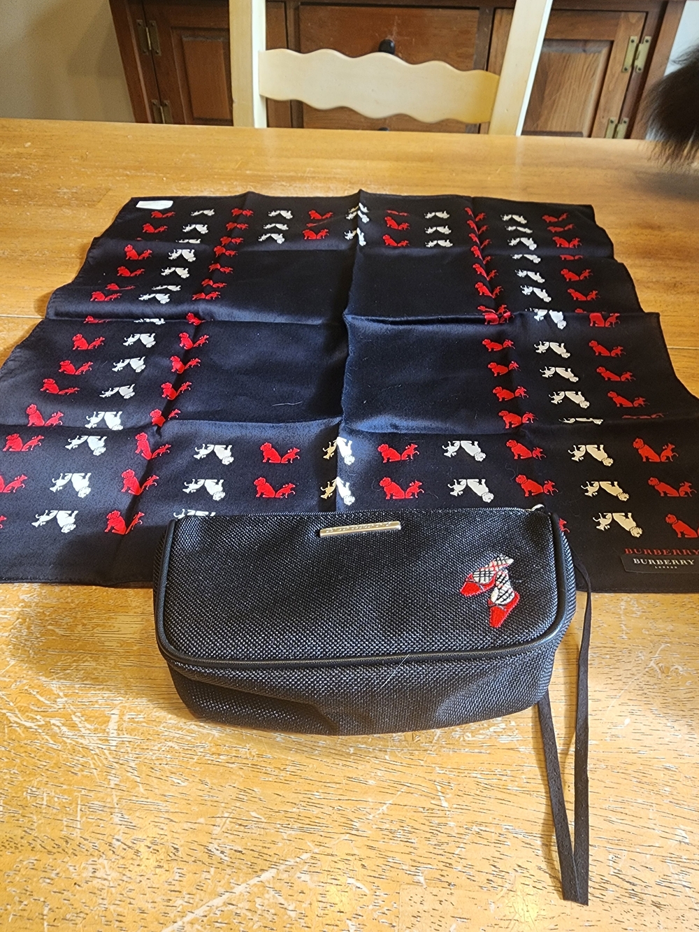 black Burberry cosmetic pouch and Burberry Scarf